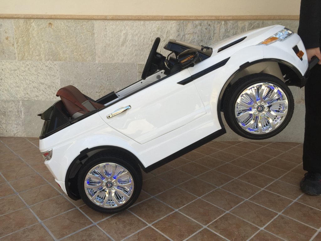 Coche electrico para niños evoque style blanco con asa de transporte