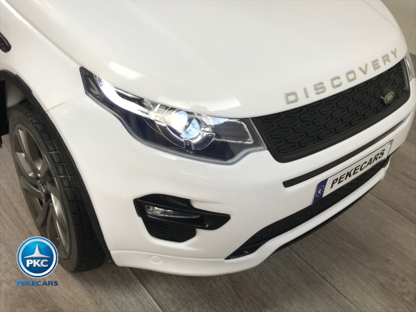 Coche eléctrico para niños Land Rover Discovery 12V MP4 blanco vista faro delantero